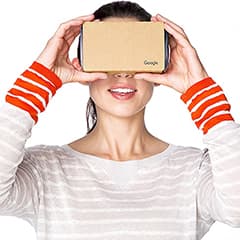 woman wearing striped shirt looking through VR Cardboard